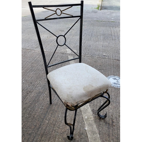 557 - A wrought metal conservatory garden suite comprising of 4 chairs and occasional table