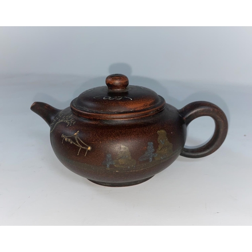 63A - A Chinese Yi Xing teapot with painted decoration raised painted decoration including characters, sea... 