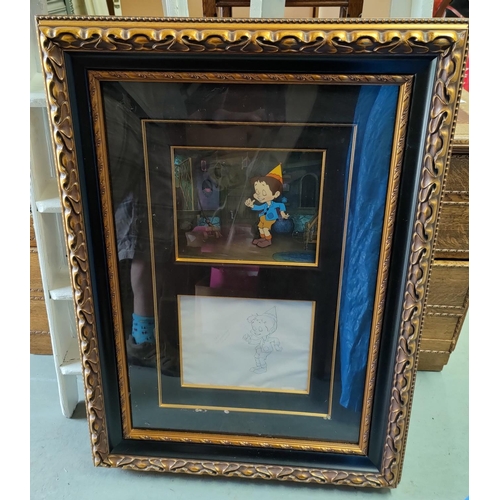475 - A film production still with a drawing of Pinocchio in a large gilt frame, glazed and with a certifi... 