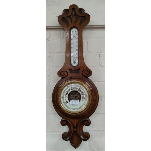 522 - An early 20th century carved aneroid barometer with thermometer,  length 65cm