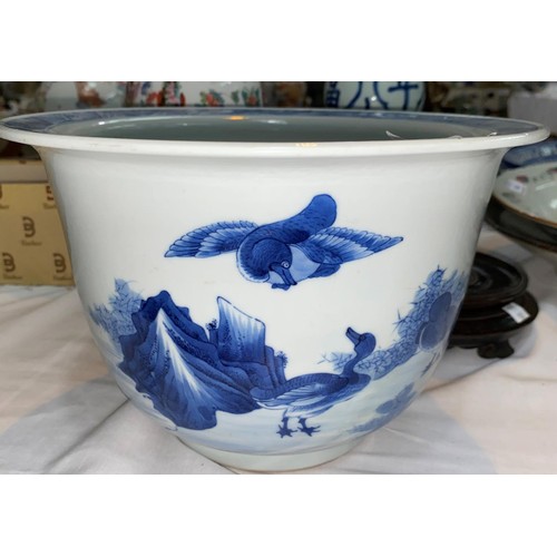 159 - A Chinese blue and white jardiniere, decorated with ducks, with hardwood stand (drill mark to base),... 