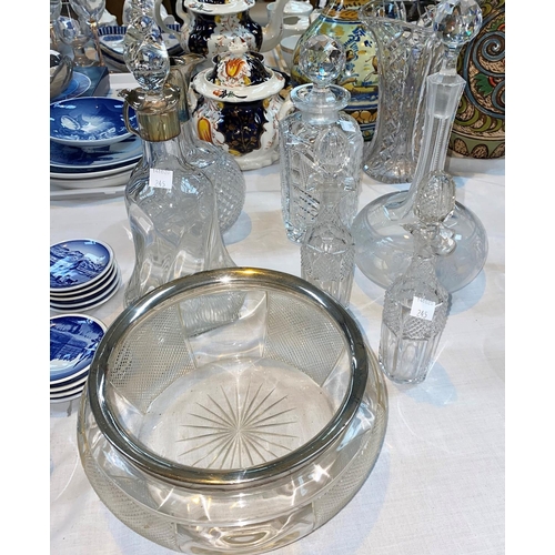 245 - A fruit bowl with silver rim; a decanter with trefoil silver rim; a claret jug; other decanters