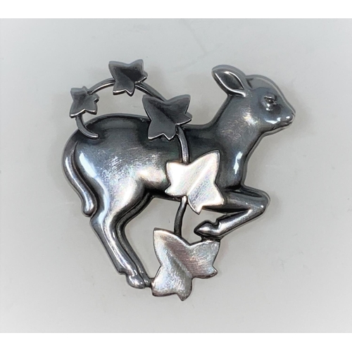 302 - Georg Jensen:  a silver brooch designed by Arno Malinowski, gambolling lamb with ivy overlay, stampe... 