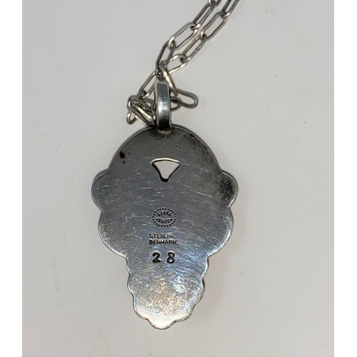 304 - Georg Jensen:  a silver pendant designed by Henning Koppel, set cabochon amethyst on silver link cha... 