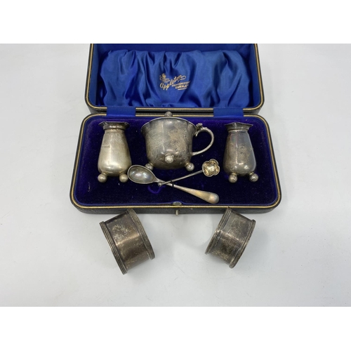 307 - A hallmarked silver 3 piece cruet with serrated rims and ball feet, cased, Sheffield; a pair of hall... 