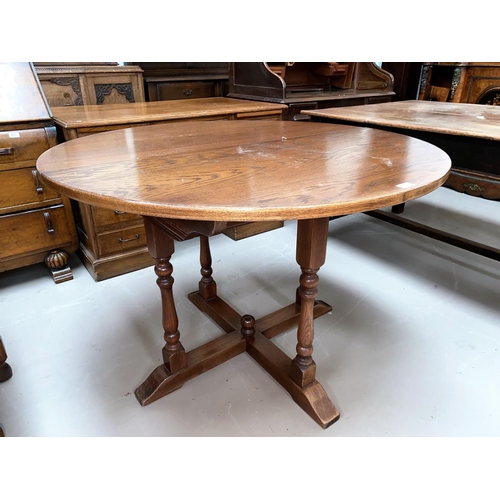 571 - An Oak old charm extending oval dining table with one spare leaf and a set of six (4+2) oak panel ba... 