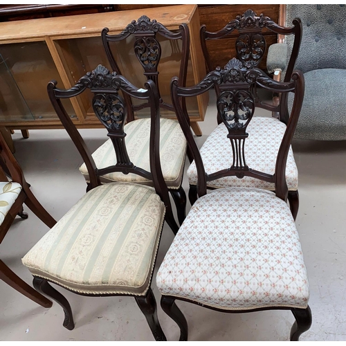575 - A set of seven Victorian mahogany salon chairs with carved backs, on cabriole legs.