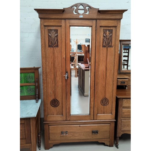 589 - An Edwardian carved oak 3 piece bedroom suite in the Arts  Crafts style comprising mirror door wardr... 
