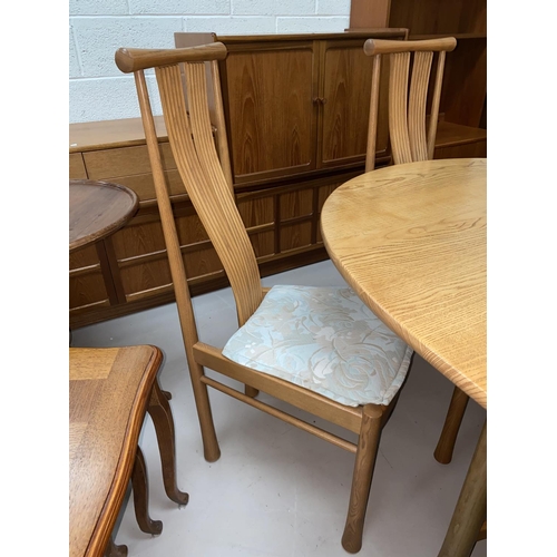 600 - An Ercol light elm dining suite comprising extending 'D' end table on trestle base, extended length ... 