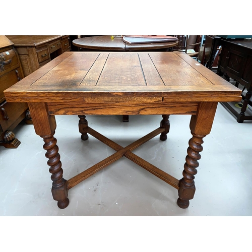 604 - An oak  drawer leaf dining table with barley twist legs
 x stretcher.