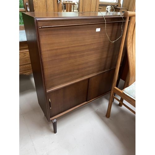 611 - A mid 20th Century teak cocktail cabinet with fall front and sliding doors below