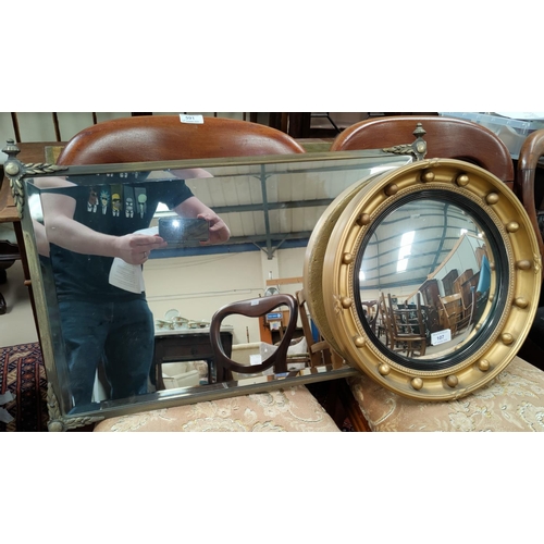 107 - A circular gilt framed convex mirror, another brass framed mirror