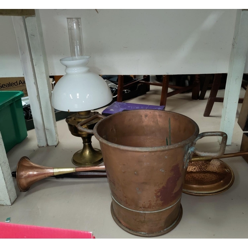 118 - A large copper coal bucket with elongated handle. Copper horn; brass jam pans; an oil lamp etc.