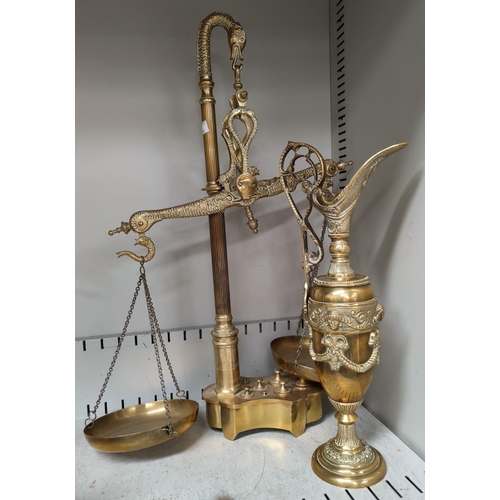 131 - A classical style decorative brass ewer and a pair of reproduction brass scales and weights