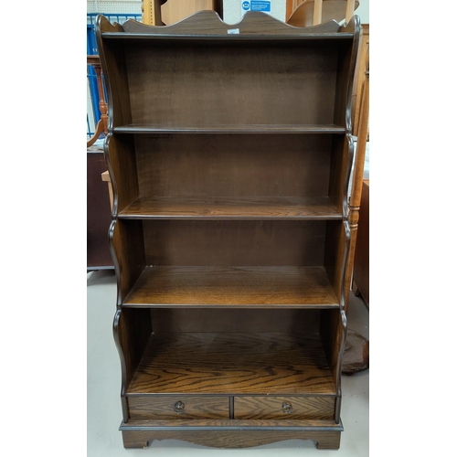 567 - An oak reproduction 'waterfall' bookcase with 5 shelves and drawers below height 148 cm x width 77cm