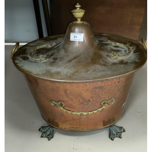 91 - A planished copper and brass oval coal bucket with tin liner ans swan feet