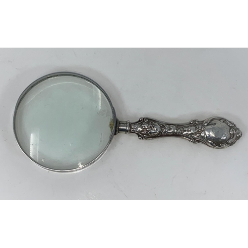 102A - An Edwardian magnifying glass with hallmarked silver embossed handle, Birmingham 1901/2