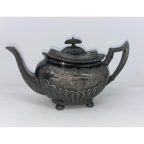 159A - A 19th century EPBM teapot with chased floral decoration and reeded lower body