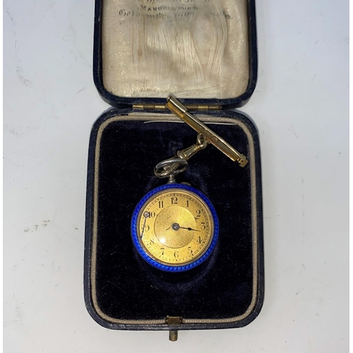 173A - An early 20th century keyless open faced white metal fob watch with gilded blue enamel decoration, g... 