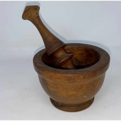 218A - A small late 19th  / early 20th century turned wood pestle and mortar