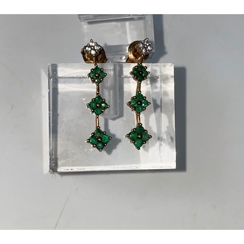 335 - A pair of 9 carat hallmarked gold earrings, each set 4 small diamonds and 12 Emeralds  2.7 gms