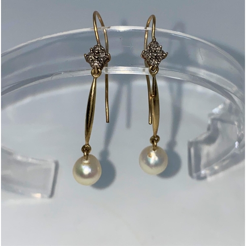 336 - An early 20th Century pair of drop earrings each set 4 small diamonds and a pearl with bar between, ... 
