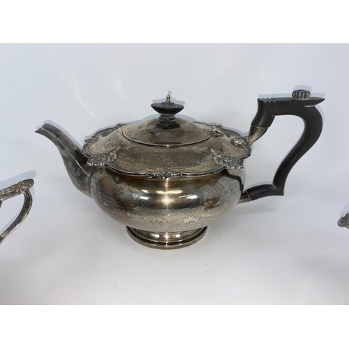 353 - A hallmarked silver 3 piece tea set in the Georgian style, circular with scalloped shell borders on ... 
