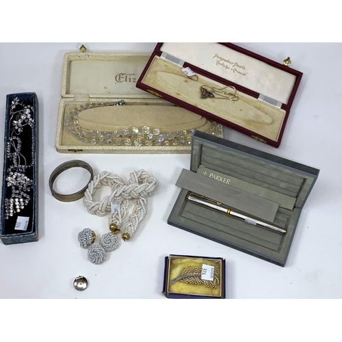 376 - An Edwardian gem set trefoil pendant on later unmarked chain; a silver hinged bangle, cased; a plait... 