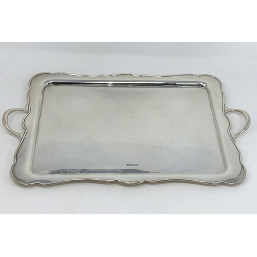 385 - A scalloped rectangular silver tray with 2 handles, Sheffield 1925, 48 oz