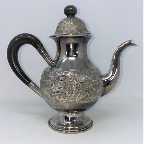 392 - A white metal coffee pot with extensive embossed decoration, tests as silver