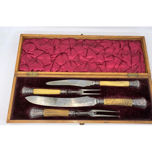 406 - An inlaid oak cased carving set by Harrison Bros. & Howson, with horned handles and hallmarked silve... 