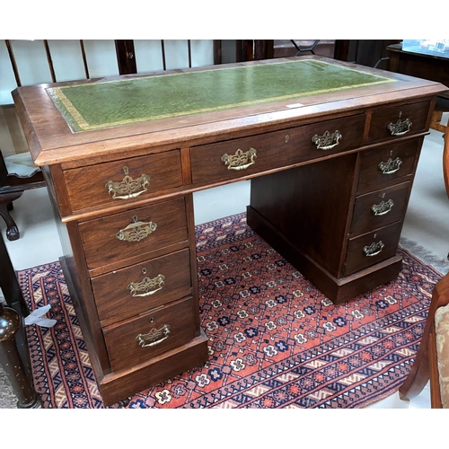 506 - An Edwardian mahogany kneehole desk with inset leather top, 8 pedestal and 1 frieze drawers