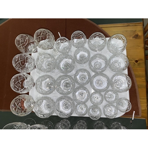143 - A part suite of 28 cut crystal drinking glasses of various sizes including hock, brandy, sherry, and... 