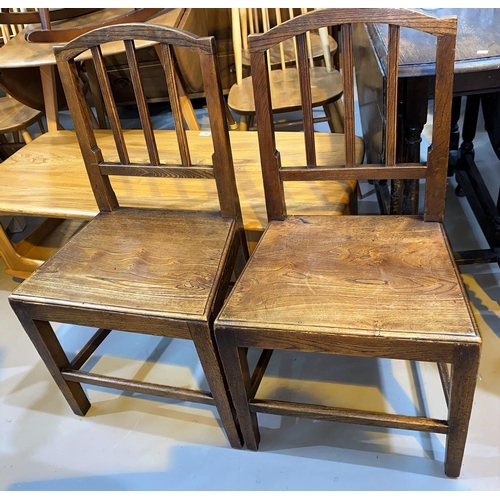 189A - A pair of Georgian country made elm rail back dining chairs with solid seats and square legs