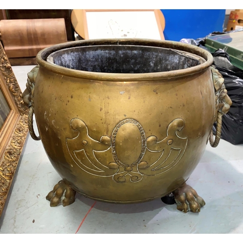 202A - A Victorian style cauldron shaped brass coal /log bucket with lion mask and ring handles and paw fee... 