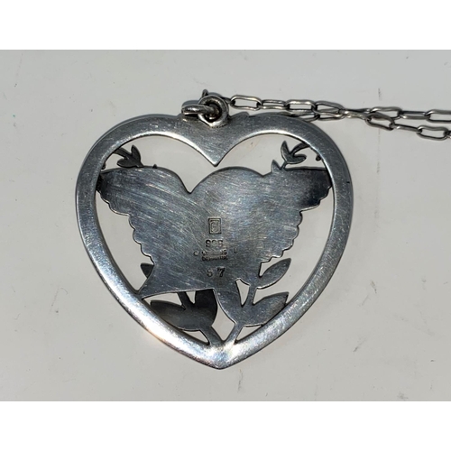 277 - Georg Jensen, a pendant of a bird with outstretched wings perched on branch, in heart shaped and pie... 