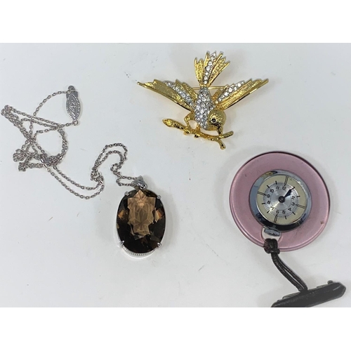 294 - A smoky quartz pendant in silver mount and chain; a medical watch; a bird on a branch brooch