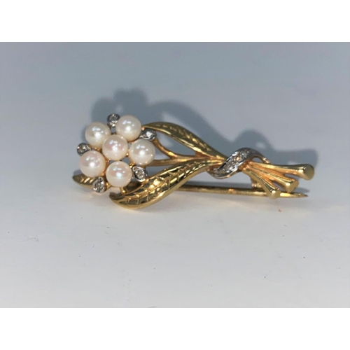 296 - A seed pearl and diamond brooch in the form of a flower, unmarked