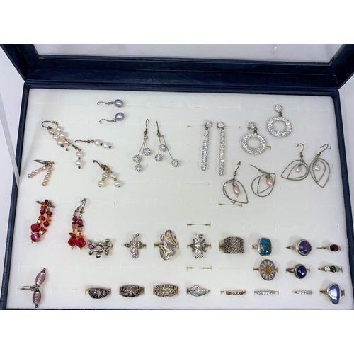 389 - A jewellery display box with a large selection of costume rings and earrings