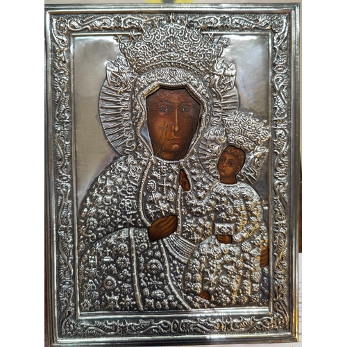 477 - A early to mid 20th century Polish painted icon with white metal surround featuring Mary and Baby Je... 