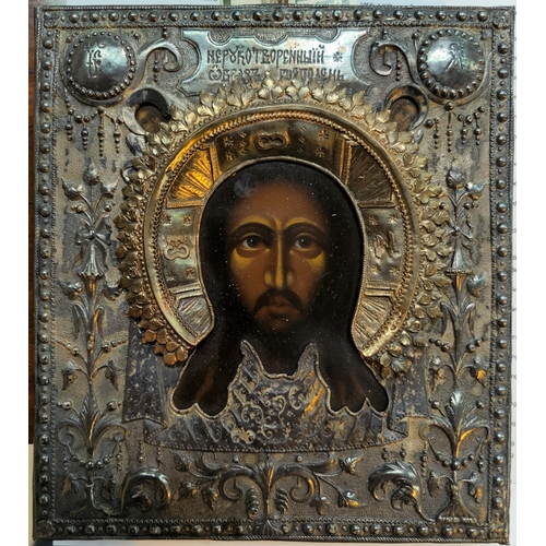 478 - A early to mid 20th century Polish painted icon with white metal surround featuring Jesus Christ