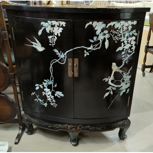 498 - A 20th century black lacquer Chinese style floor standing corner cupboard with mother of pearl decor... 
