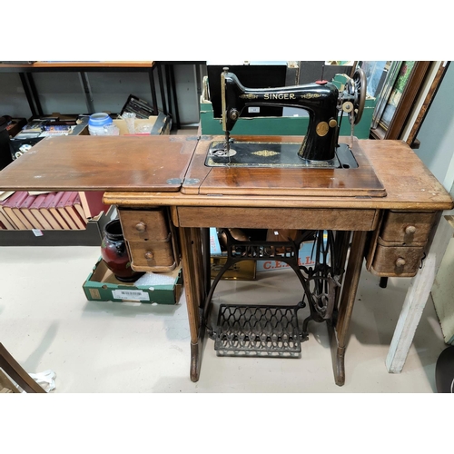 539A - A Singer treadle sewing machine on cast iron stand.