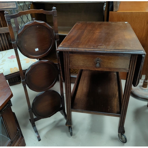 587 - A 2 tier tea trolley with drop leaf; a folding 3 height cake stand; a walnut hall table