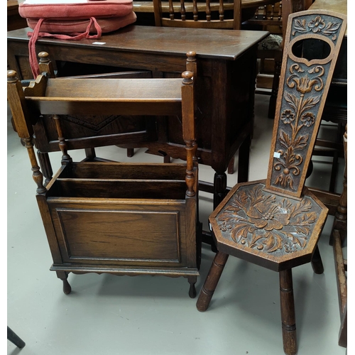 588 - An oak magazine rack/bookshelf; a spinning chair; a 1930's low seat armchair
