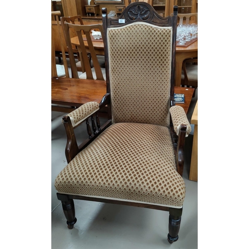 593 - An Edwardian armchair in gold patterned upholstery
