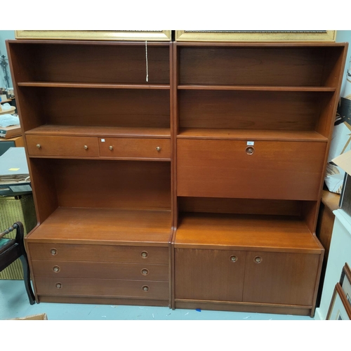 605 - A pair of mid-century teak full height bookcase/wall units; one with shelves and drawers; one with c... 