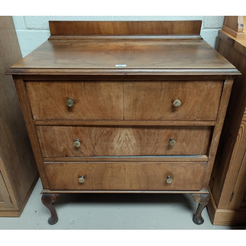 619 - A burr walnut chest of three long drawers with bakelite handles and cabriole legs
