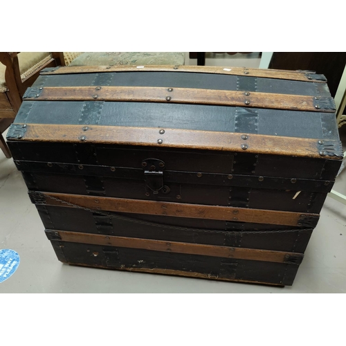 625 - A late Victorian wood and metal bound domed top trunk with interior fitting 76cm