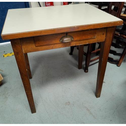 640 - An oak worktable with single drawers and Formica top.